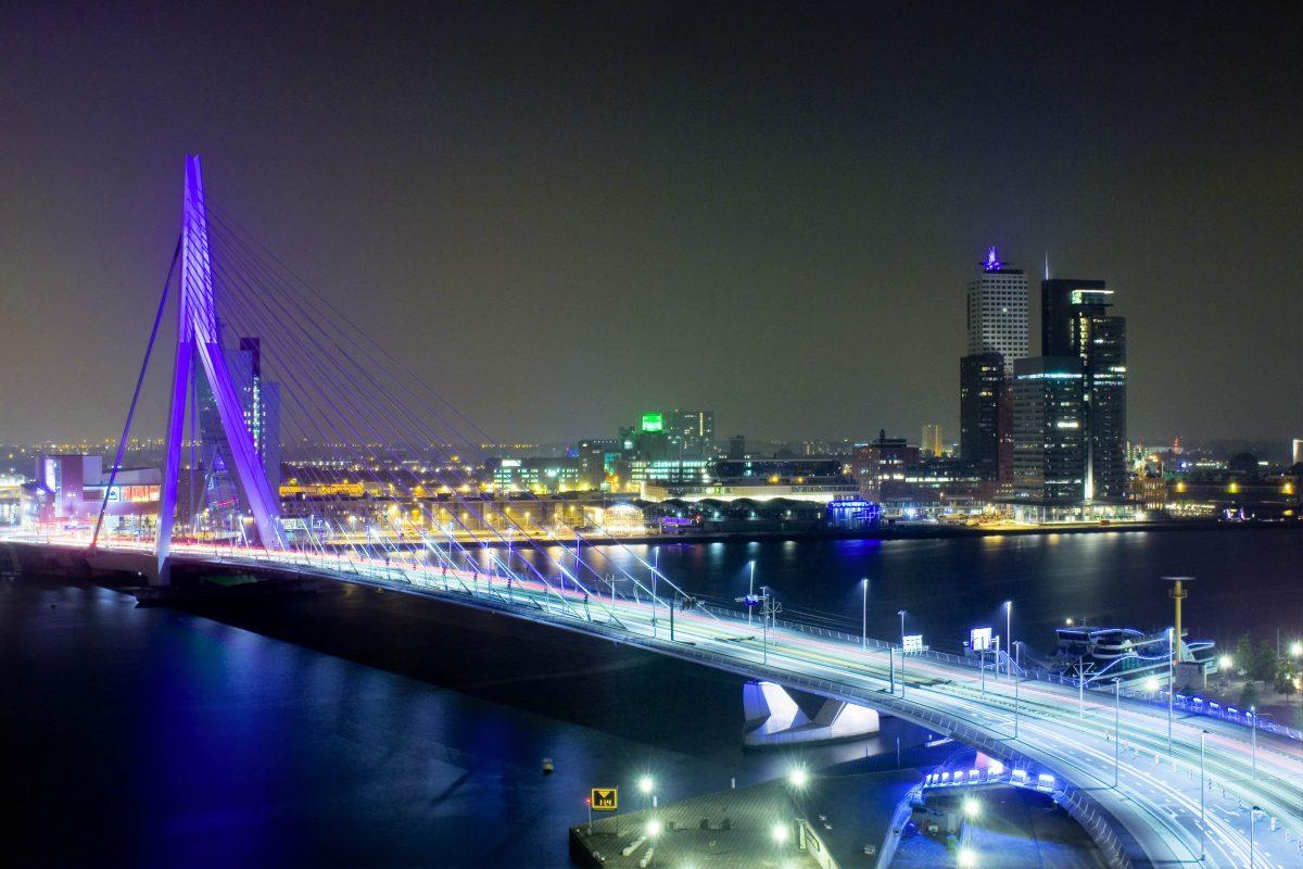 At night, Rotterdam's Erasmus Bridge is illuminated in spectacular colors and even more magnificent to behold than in daylight, Netherlands - © Corepics VOF / Shutterstock